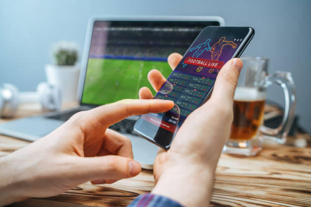 istock Man celebrating victory after making bets at bookmaker website 1141068321