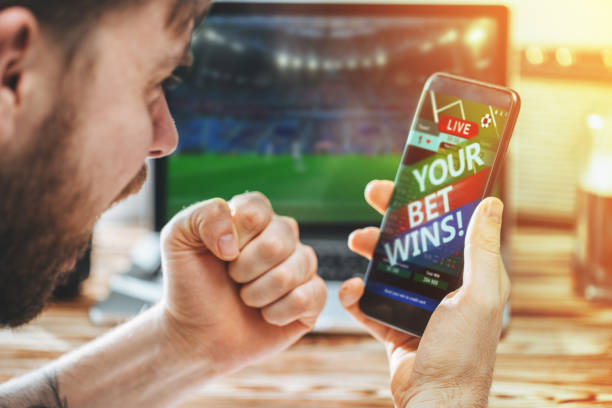 istock Man celebrating victory after making bets at bookmaker website 1141068390