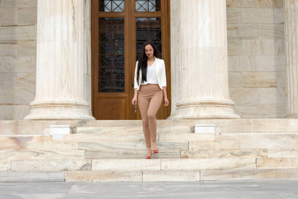 istock Elegant woman exiting building 1141068422