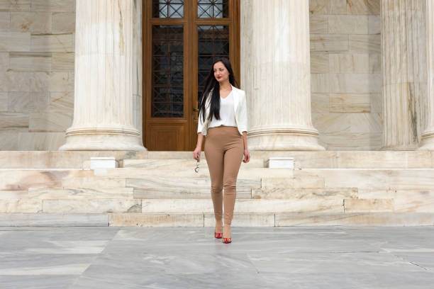 istock Elegant woman exiting building 1141068424