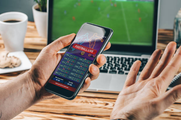 istock Man celebrating victory after making bets at bookmaker website 1141068487