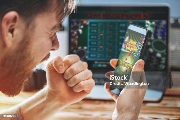 Man Celebrating Victory After Making Bets At Bookmaker Website Stock Photo - Download Image Now