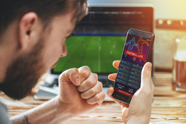 istock Man celebrating victory after making bets at bookmaker website 1141068559