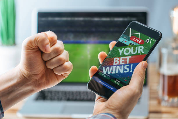 istock Man celebrating victory after making bets at bookmaker website 1141068577