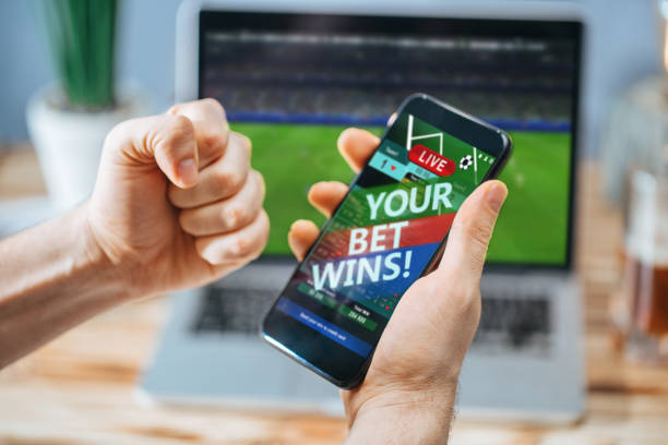 istock Man celebrating victory after making bets at bookmaker website 1141068597