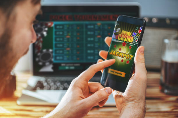 istock Man celebrating victory after making bets at bookmaker website 1141068665