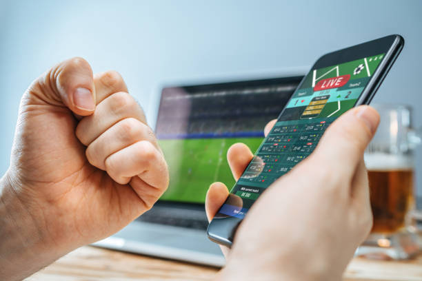 istock Man celebrating victory after making bets at bookmaker website 1141068730