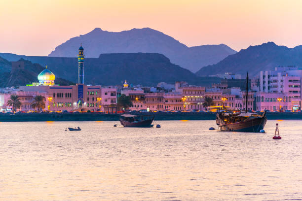 View of coastline of Muttrah district of Muscat during sunset, Oman. View of coastline of Muttrah district of Muscat during sunset, Oman. dhow photos stock pictures, royalty-free photos & images