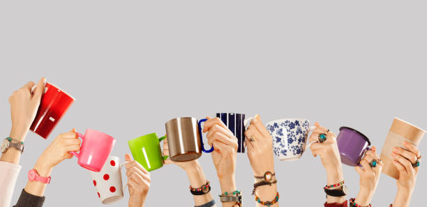 istock Many different arms raised up holding coffee cup 1141069962