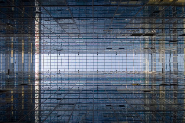 istock Perspective and underside angle abstract view to textured background of modern glass office building 1141071516