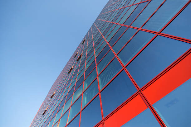 istock Perspective and underside angle abstract view to textured background of modern glass office building 1141071530