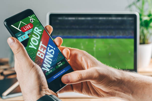 istock Man celebrating victory after making bets at bookmaker website 1141074679