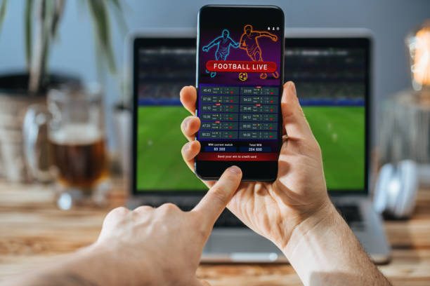 istock Man celebrating victory after making bets at bookmaker website 1141074861