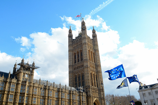 E.U. Flag flying in front of Union ack flag at Houses of Parliament London