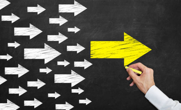 istock yellow arrow leading to white arrows 1141077110