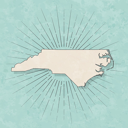 Map of North Carolina in a trendy vintage style. Beautiful retro illustration with old textured paper and light rays in the background (colors used: blue, green, beige and black for the outline). Vector Illustration (EPS10, well layered and grouped). Easy to edit, manipulate, resize or colorize.