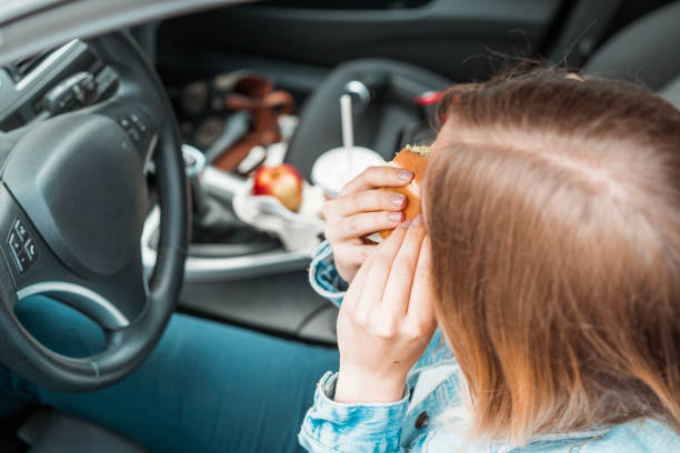 istock Taking a bite of a burger in a messy car 1141083546