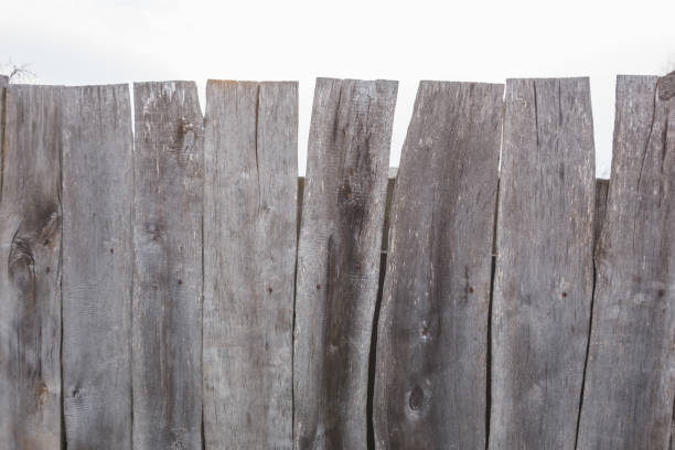 istock Texture of a gray curve fence from old boards 1141088537
