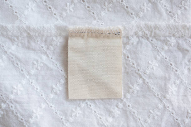 istock blank laundry care clothes label on fabric texture background 1141094303