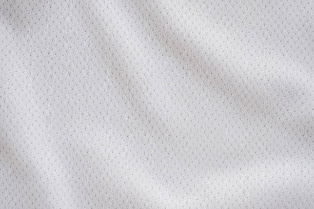 White fabric sport clothing football jersey with air mesh texture background White fabric sport clothing football jersey with air mesh texture background sports uniform photos stock pictures, royalty-free photos & images