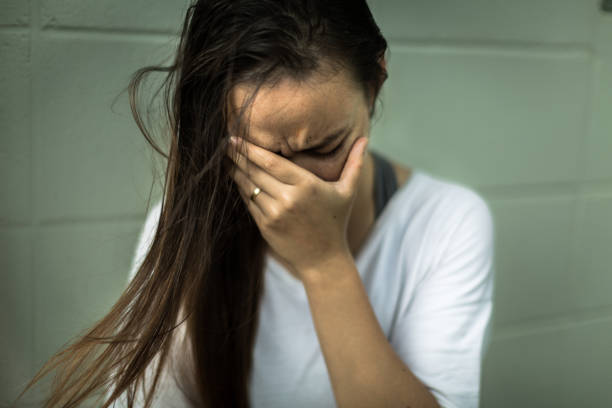 istock depressed sad woman covering her face with her hands, crying. 1141094688