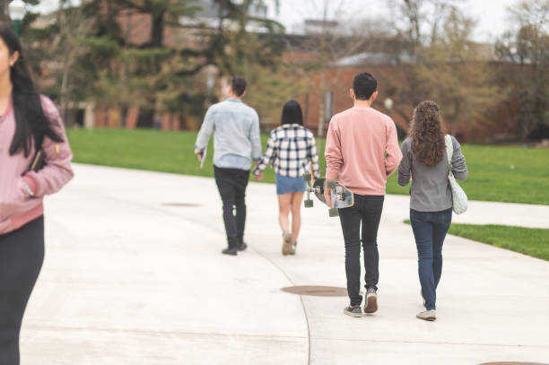 istock College students walking across campus to their classes 1141096045