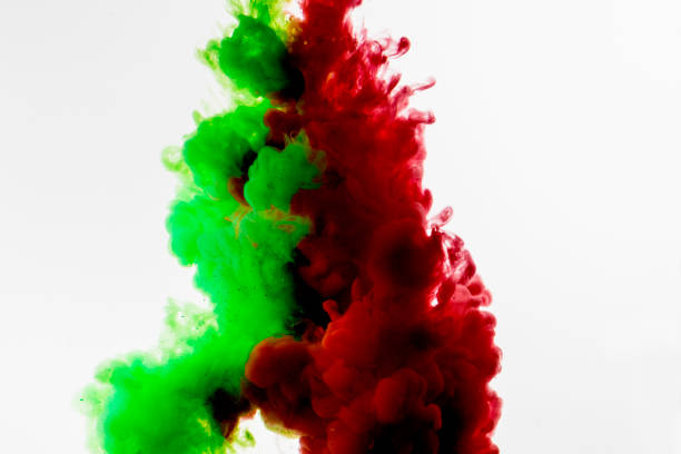 istock Green and red colored abstract acrylic paint spraiyng on a white background. 1141096089