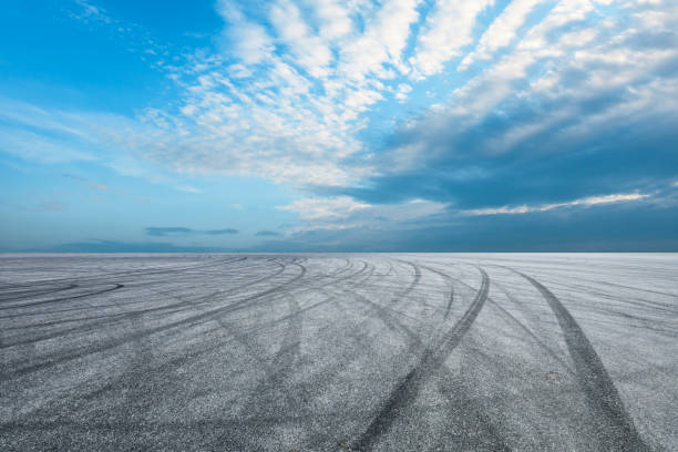 istock Asphalt race track ground and beautiful sky clouds 1141097494
