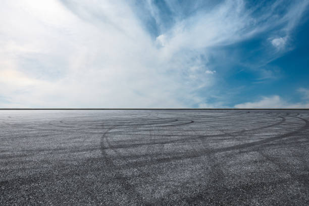 istock Asphalt race track ground and beautiful sky clouds 1141098745