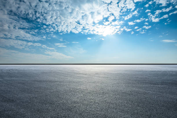 istock Asphalt race track ground and beautiful sky clouds 1141099572