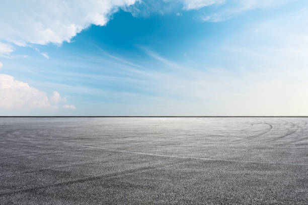 istock Asphalt race track ground and beautiful sky clouds 1141101610