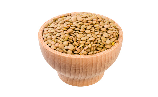 Green lentils  in wooden bowl isolated on white background. nutrition. food ingredient.