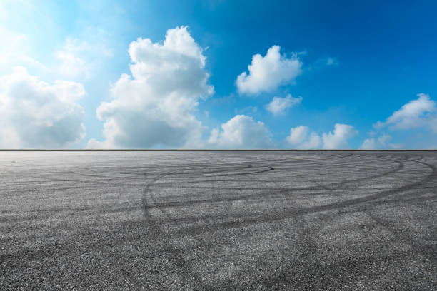 istock Asphalt race track ground and beautiful sky clouds 1141101676
