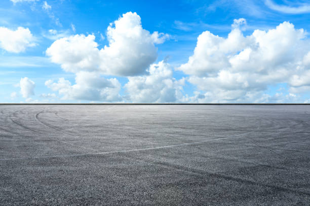 istock Asphalt race track ground and beautiful sky clouds 1141102258