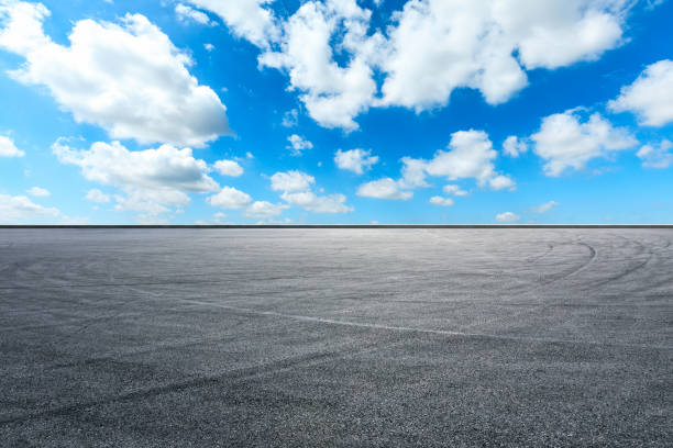 istock Asphalt race track ground and beautiful sky clouds 1141103898