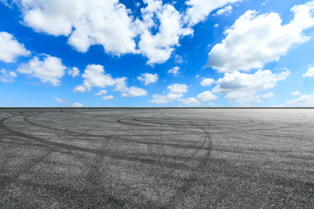 istock Asphalt race track ground and beautiful sky clouds 1141104002