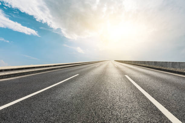 istock Asphalt road ground and blue sky with white clouds scene 1141104065
