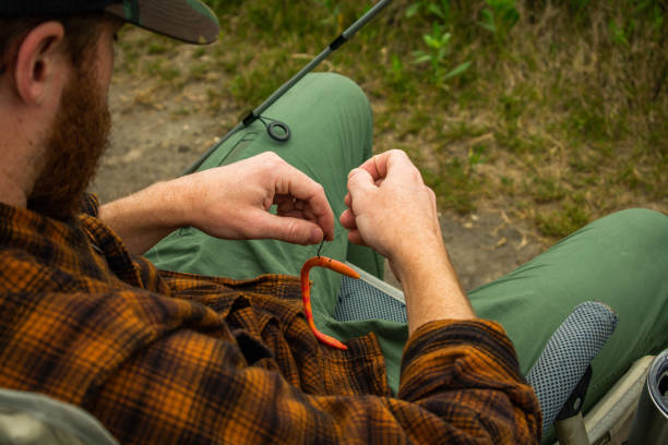 istock Fisherman In Action With Reel In Foreground Reeling in Fish 1141105292