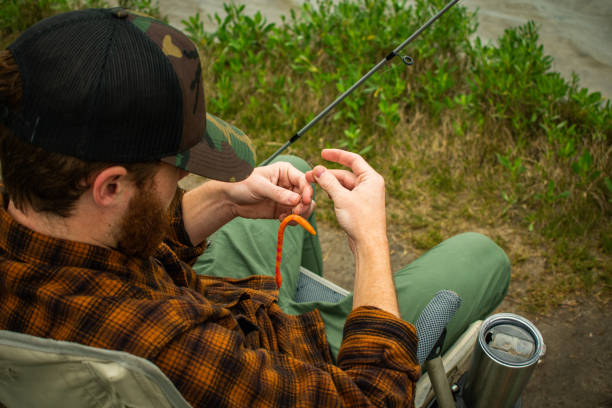 istock Fisherman In Action With Reel In Foreground Reeling in Fish 1141106464