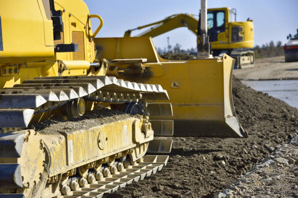 lâmina da escavadora para expulsar a terra e a areia para nivelar acima: trabalho da engenharia civil - caterpillar truck - fotografias e filmes do acervo