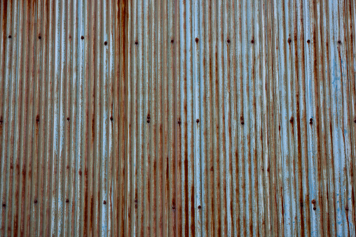 Close-up of rusted grunge corrugated iron wall.