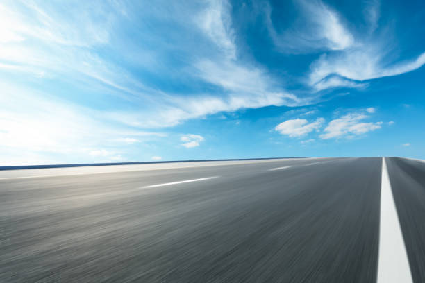 istock Motion blurred asphalt road ground and sky clouds 1141110755