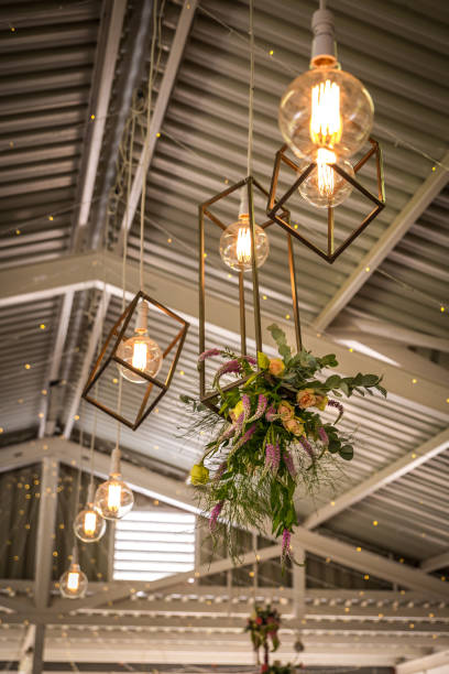istock Flowers hanging in the ceiling at a wedding.  Ceiling floral decoration. 1141112090