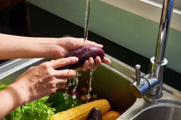 istock Housewife rinsing vegetables 1141113433