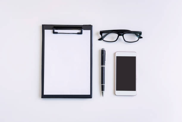 istock Empty screen Smart phone and file folder on business desk office with copy space, Top view 1141114492