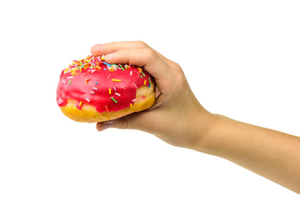 istock Two fresh red-glazed doughnuts on a black wooden table. 1141114543