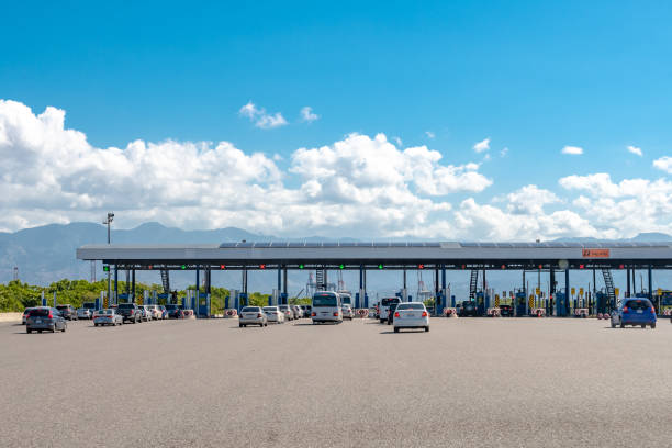 Lanes of cars in traffic at the Portmore Toll Plaza in Jamaica Portmore, Jamaica - March 19 2019: Lanes of cars in traffic at the Portmore Toll Plaza on the Causeway/Highway to Kingston cash in transit vehicle stock pictures, royalty-free photos & images