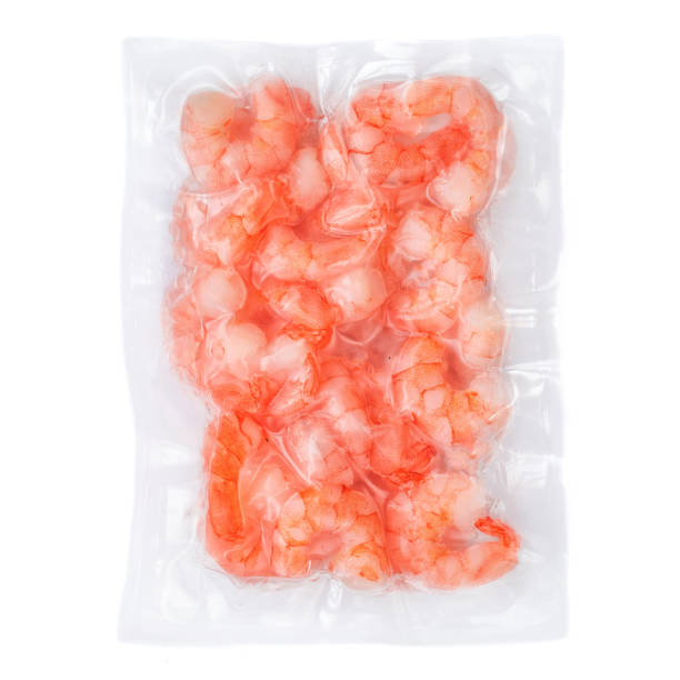 istock Frozen  shrimps in a vacuum package  isolated on white background. Top view 1141124607
