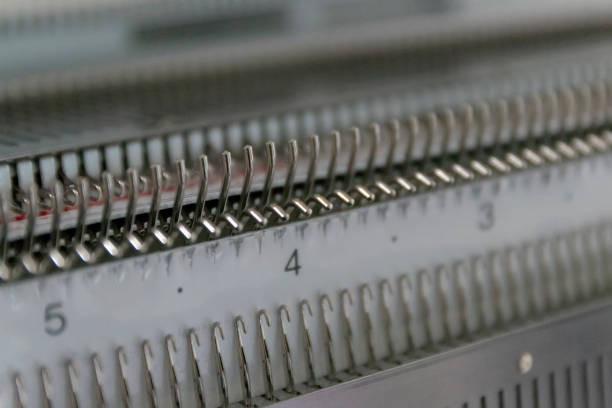 istock Manual knitting machine. A knitting machine is a device used to create knitted fabrics 1141130102
