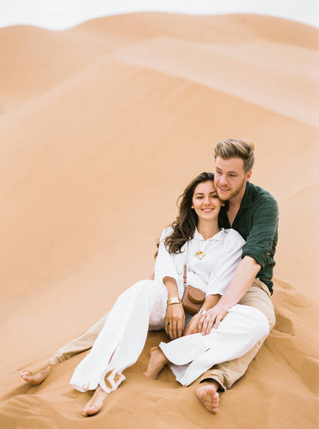 istock Loving couple in Sahara Desert. 1141130246